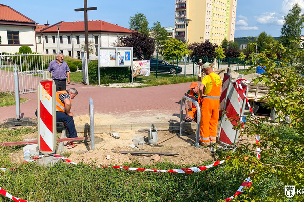 Trzech pracowników Zieleni Miejskiej montuje stojaki rowerowe